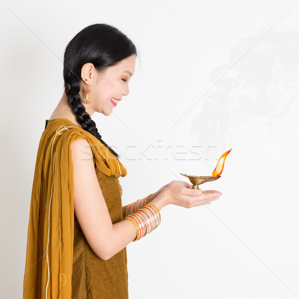 Girl holding diya light Stock photo © szefei