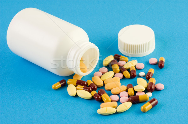 Pills spilled out of a bottle Stock photo © szefei