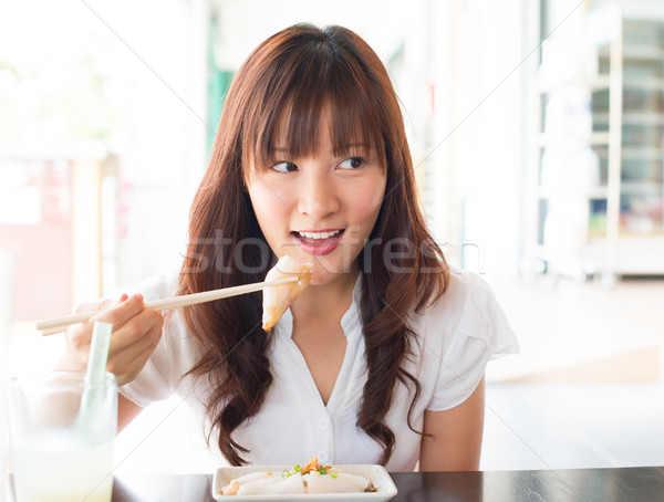Asian girl eating dim sum Stock photo © szefei