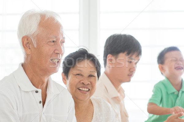 Happy Asian family indoors Stock photo © szefei