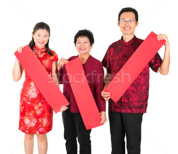 Asian Chinese family holding red spring couplets Stock photo © szefei