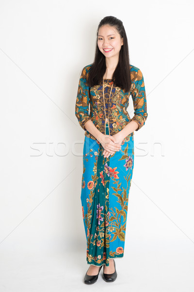 Southeast Asian girl in batik dress smiling Stock photo © szefei