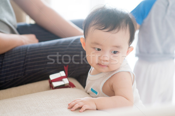 Nine months old baby learning to walk. Stock photo © szefei
