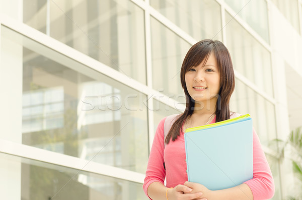 Young Asian college girl student at school campus Stock photo © szefei