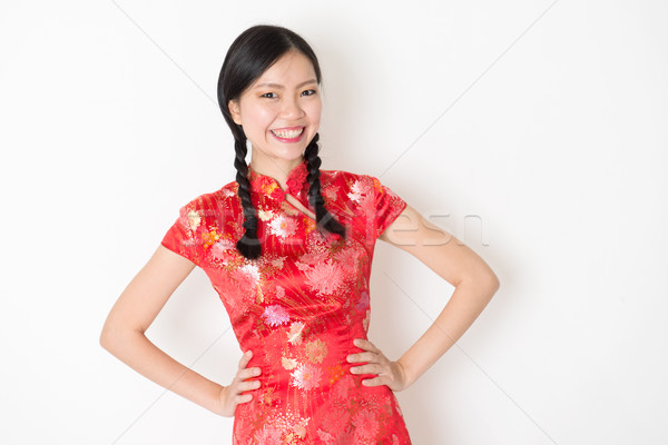 Oriental girl in red qipao smiling Stock photo © szefei