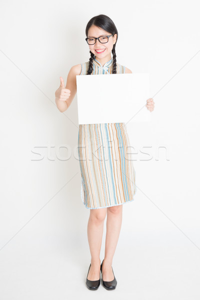 Chinese female holding white blank paper card Stock photo © szefei