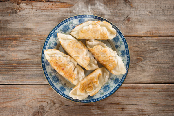 Asian appetizer pan fried dumplings Stock photo © szefei