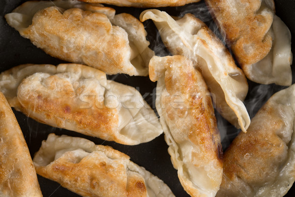 Close up Asian food fried dumpling in cooking pan Stock photo © szefei