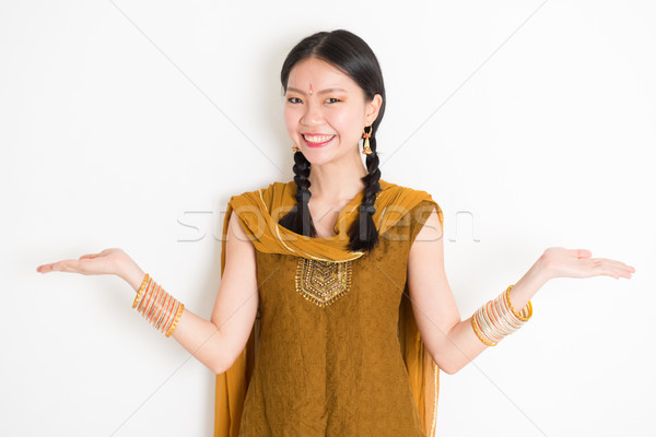 Stock photo: Mixed race Indian woman showing something