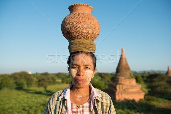 Portrait of Asian traditional farmer carrying pot on head Stock photo © szefei