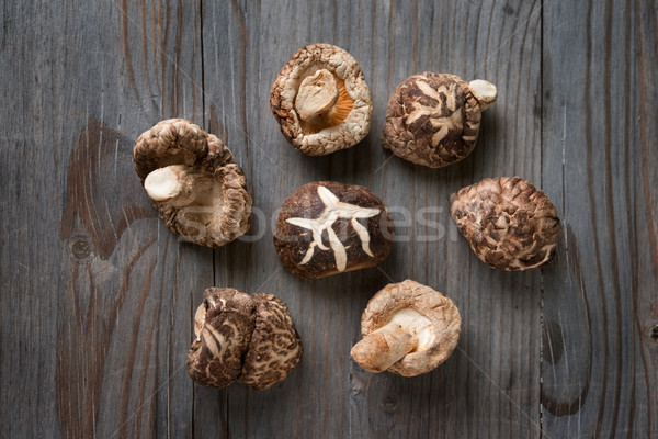 Shiitake mushrooms on wood background Stock photo © szefei