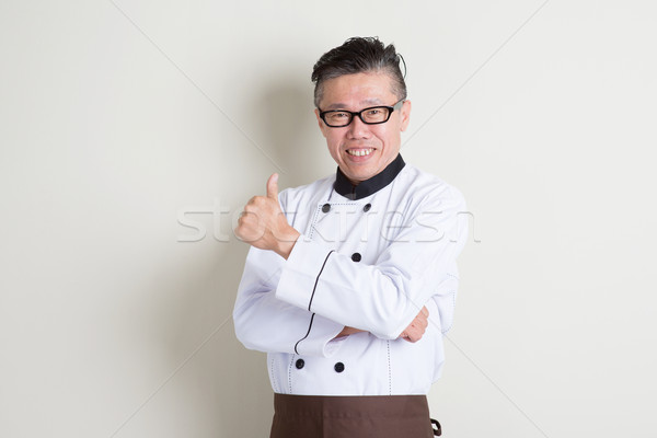 Mature Asian Chinese chef giving thumb up Stock photo © szefei