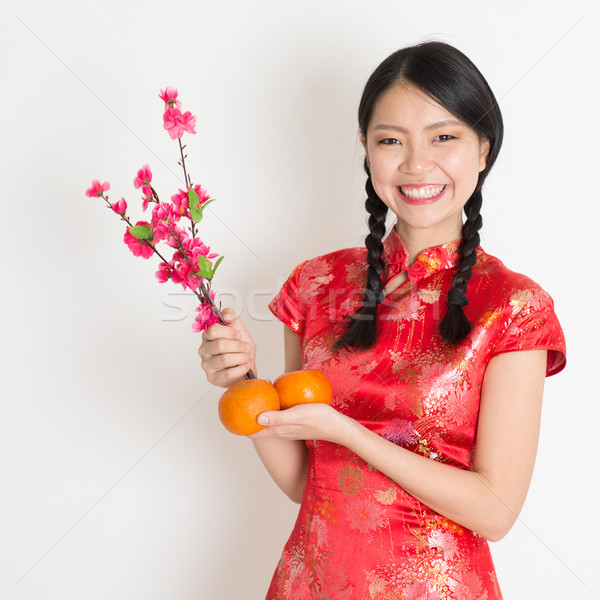Asian chinese girl holding tangerine and plum blossom Stock photo © szefei