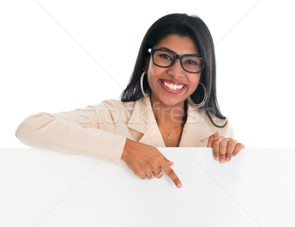 Stock photo: Indian woman holding and pointing to blank billboard.