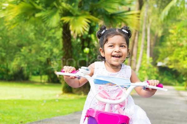 Cute Indian girl biking  Stock photo © szefei