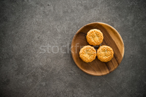 Mid-Autumn Festival Mooncakes with copy space on low light backg Stock photo © szefei