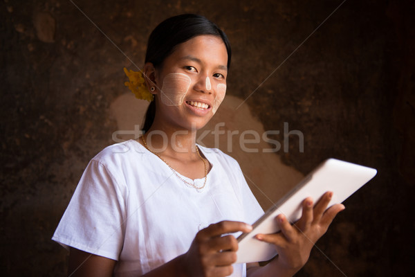Myanmar girl using tablet computer Stock photo © szefei