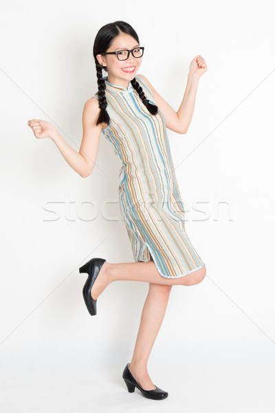 Excited Asian woman jumping around Stock photo © szefei
