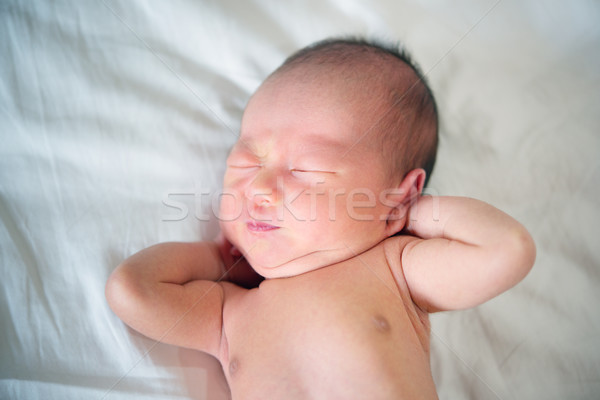 Newborn baby wakes up and stretches Stock photo © szefei