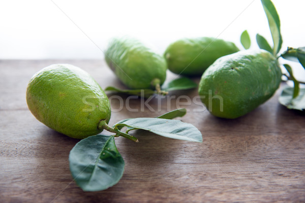 Fresg organic green lemons with leaves Stock photo © szefei