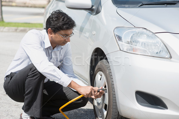 Indian people filling air to the car tires. Stock photo © szefei