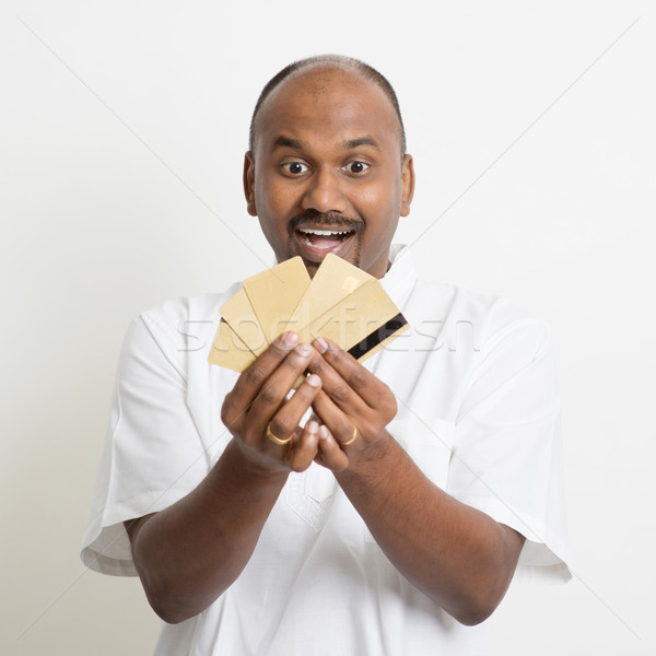 Mature casual business Indian man holding many credit cards Stock photo © szefei