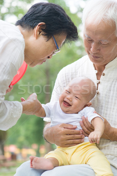 Asian grandparents playing with grandchild Stock photo © szefei