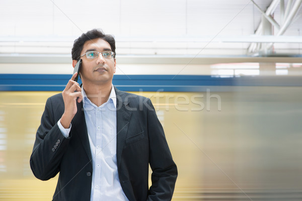 Stock photo: Talking on phone at train station