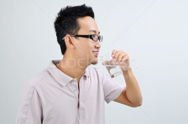 Asian male drinking mineral water Stock photo © szefei