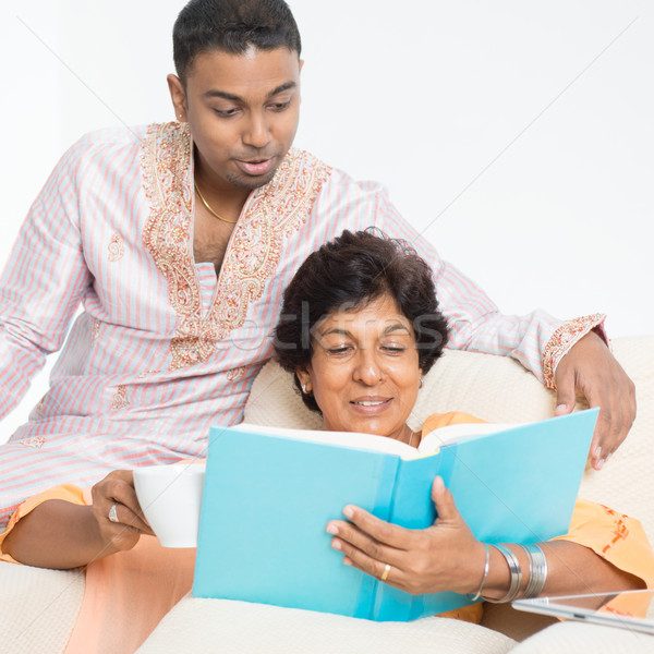 Indian family reading book together Stock photo © szefei