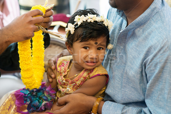 Baby girl received flower garland from priest.  Stock photo © szefei