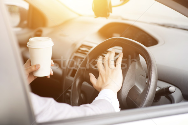 Hand on steering and honking Stock photo © szefei