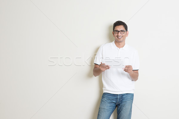 Indian male using tablet Stock photo © szefei