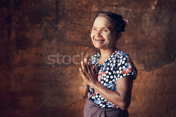 Portrait of traditional Asian Burmese woman greeting, standing inside a temple, low light, Bagan, My Stock photo © szefei