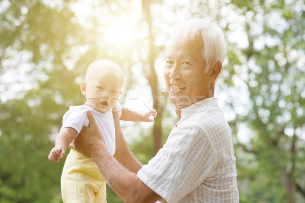 Grandparent and grandchild at park. Stock photo © szefei