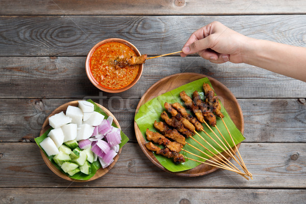 People eating sate Stock photo © szefei