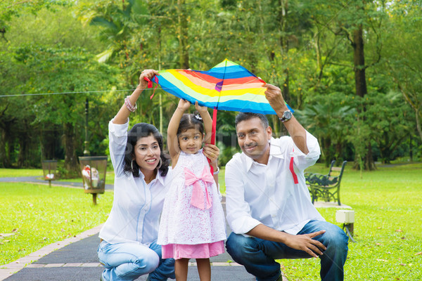 Parents flying kite with child Stock photo © szefei