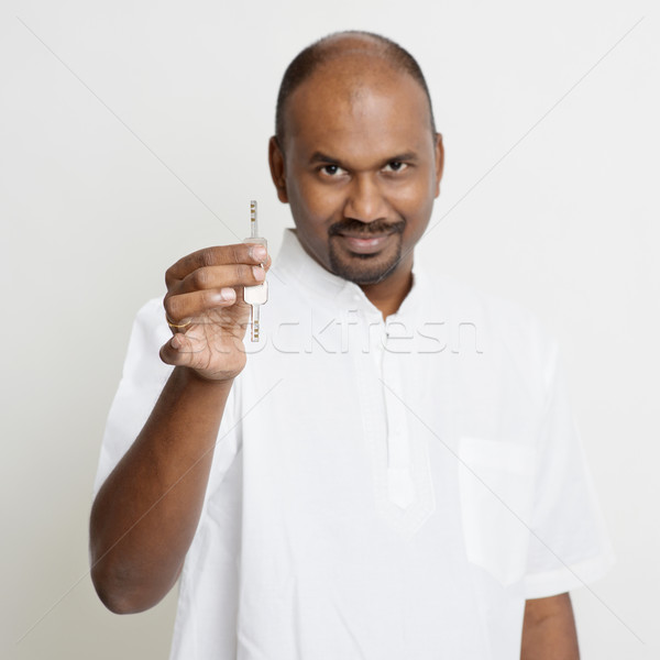 Stock photo: Mature Indian man holding house key