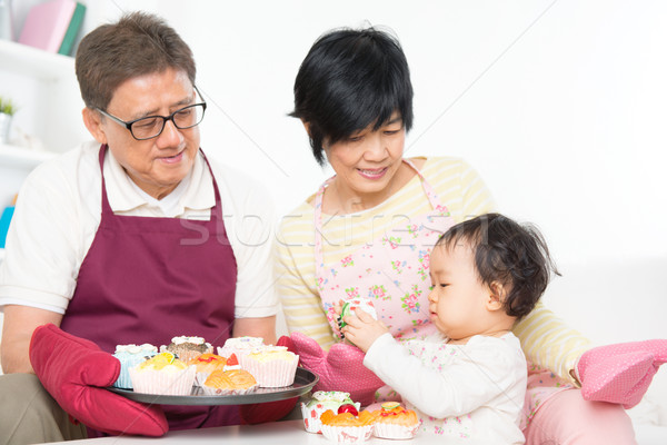 Asian family baking cake Stock photo © szefei