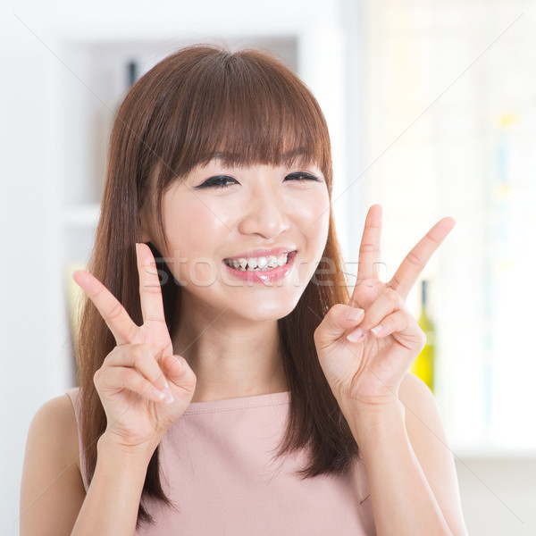 Asian girl showing v hands sign Stock photo © szefei