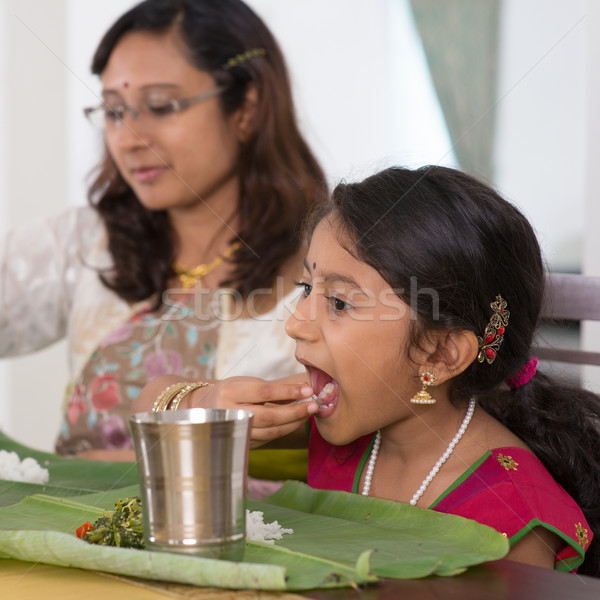 Indian family eating dinner at home Stock photo © szefei