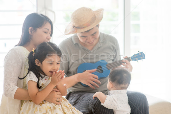 Asian family playing ukulele  Stock photo © szefei