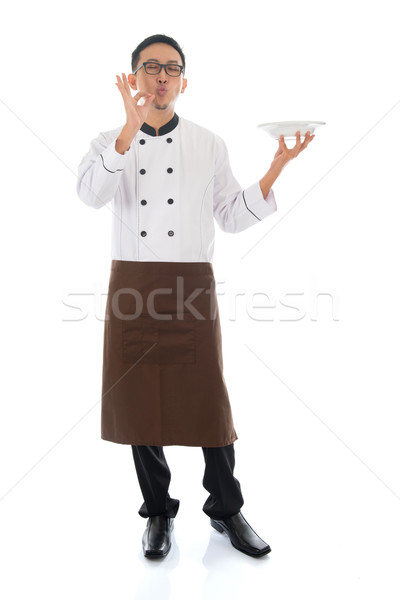 Stock photo: Asian chef holding a plate