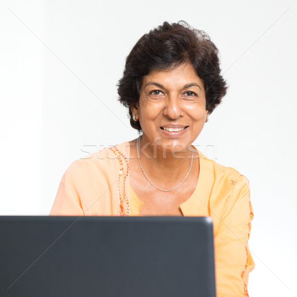 Indian mature woman notebook computer Stock photo © szefei