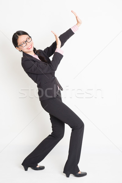 Asian businesswoman blocking something away Stock photo © szefei
