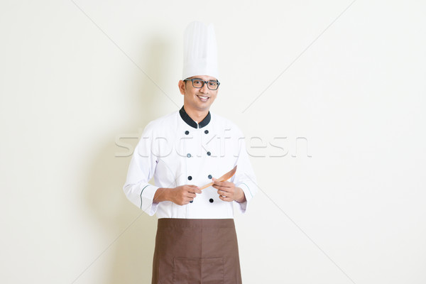 Indian male chef in uniform holding kitchen tool Stock photo © szefei
