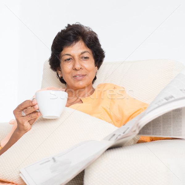 Indian mature mother reading newspaper Stock photo © szefei