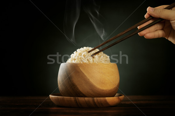 Cooked organic basmati brown rice with steam and chopsticks Stock photo © szefei