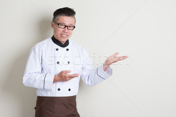 Mature Asian Chinese chef showing something Stock photo © szefei