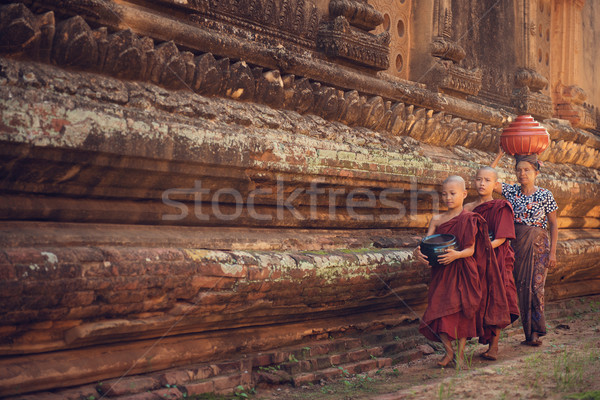 Buddhist novice monks walking alms Stock photo © szefei
